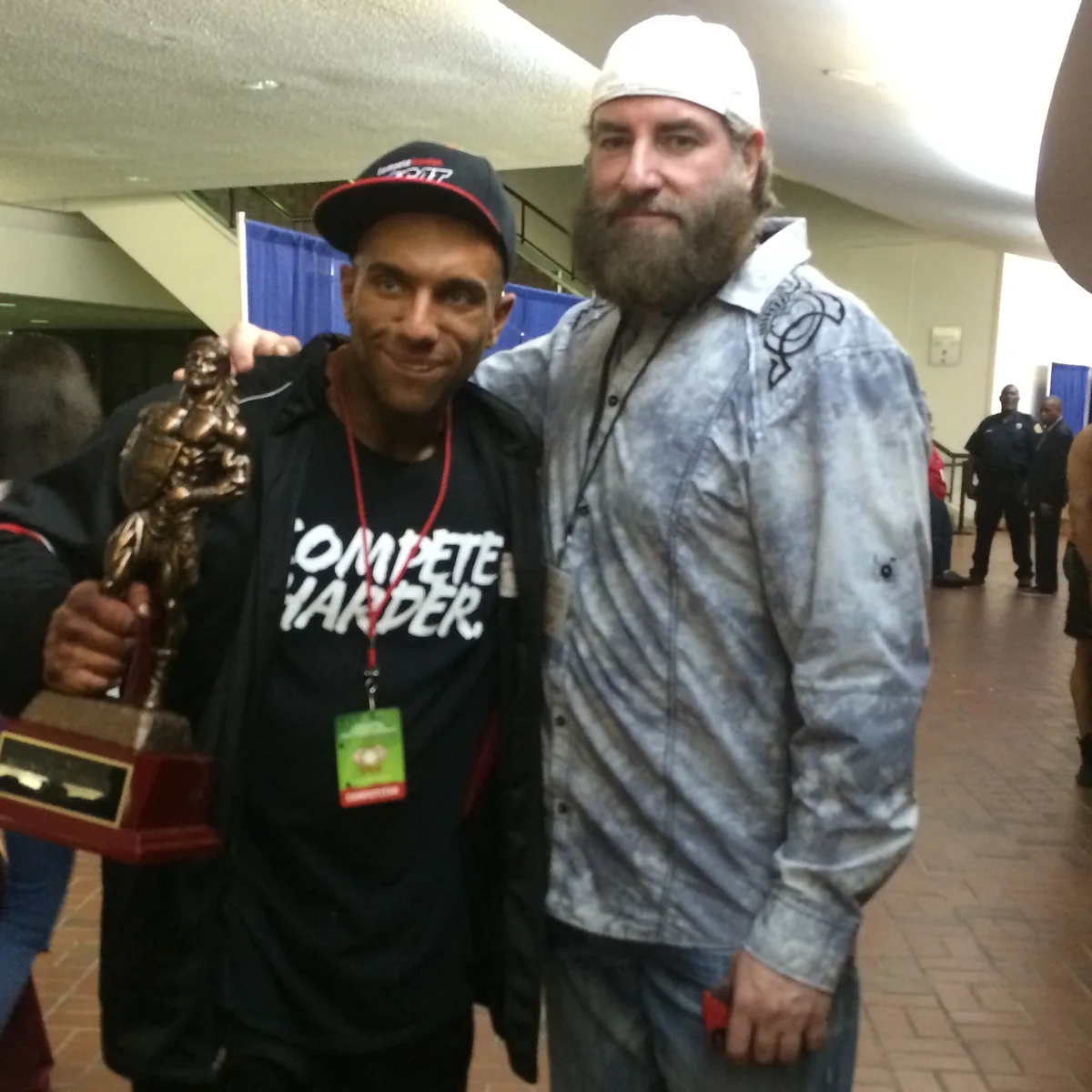 Competition day at an NPC show, a first place trophy in hand.